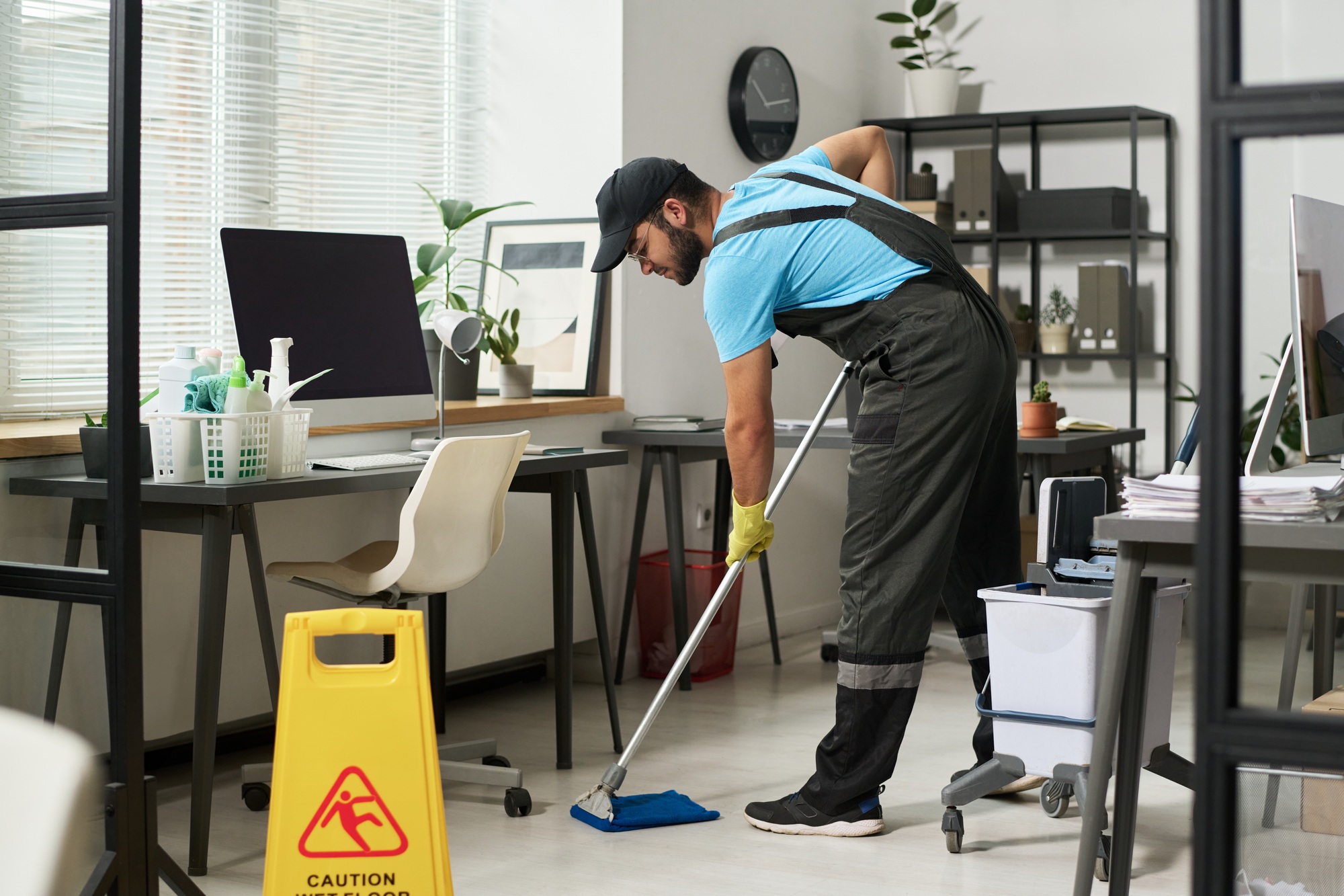 Man Cleaning Floor In Office